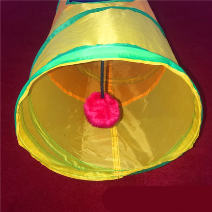 Inside view of a rainbow cat tunnel with hanging pom-pom toy